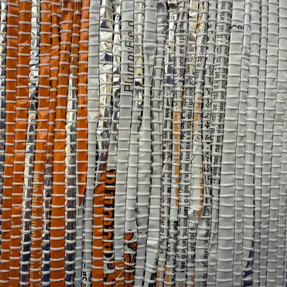 Handwoven upcycled collapsible storage basket weave in orange and gray colors.