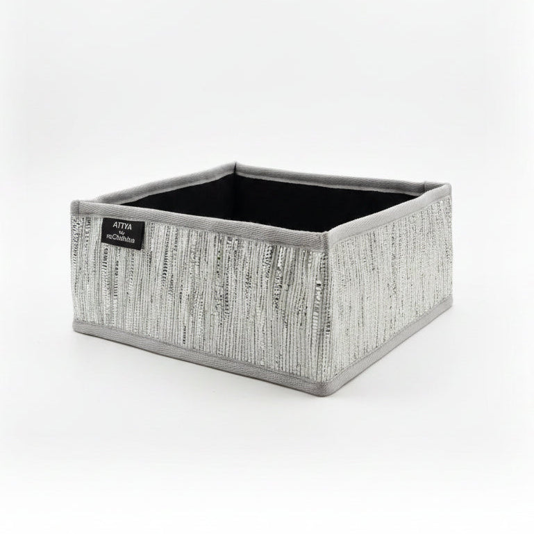 Storage basket with grey trim ans silver weave.