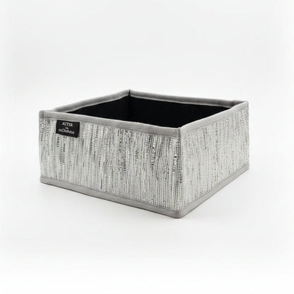 Storage basket with grey trim ans silver weave.