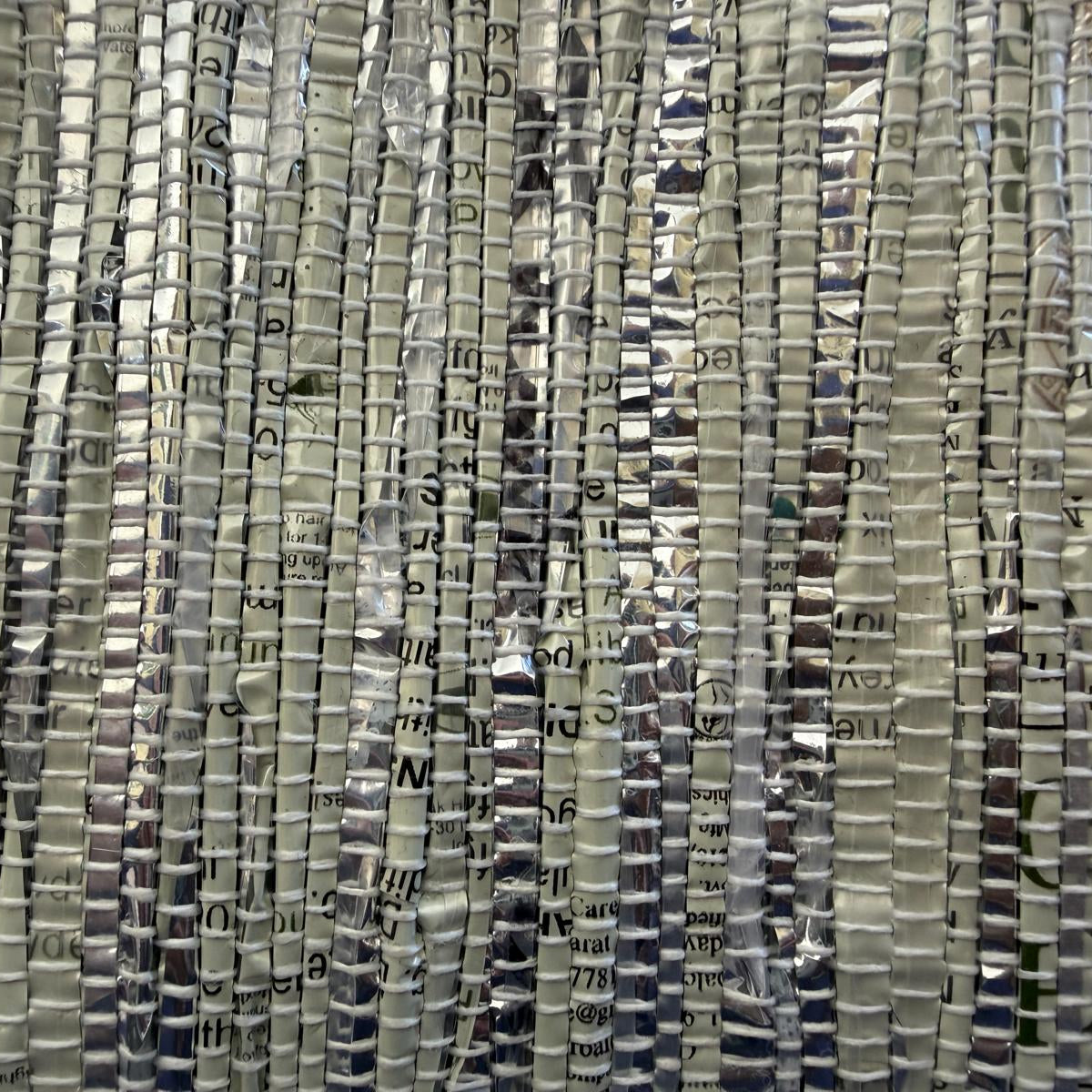 Close-up of hand-woven collapsible storage basket small in silver & grey.