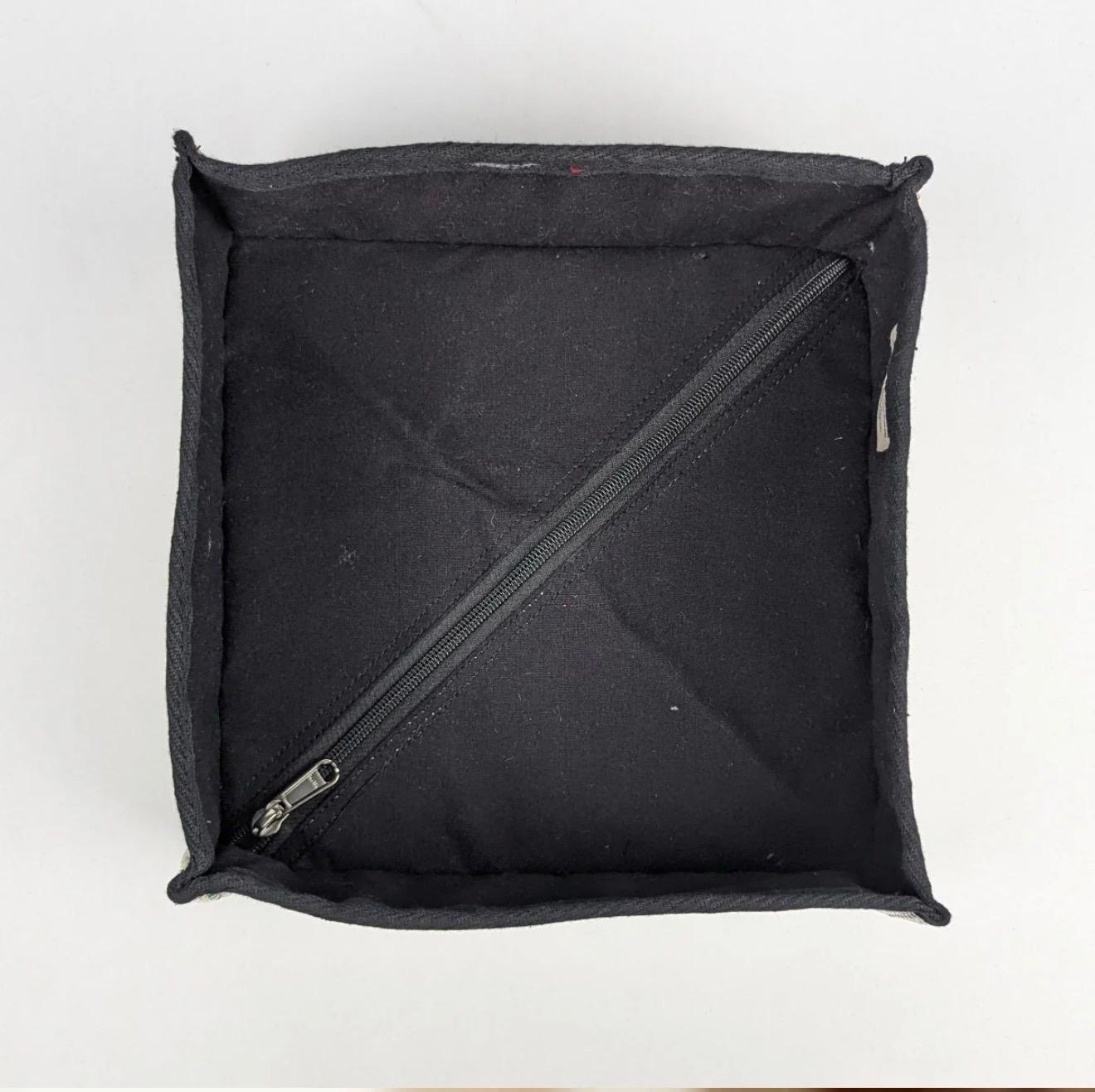 Inside view of the upcycled handwoven storage basket with a zipper to collapse the box when not in use.