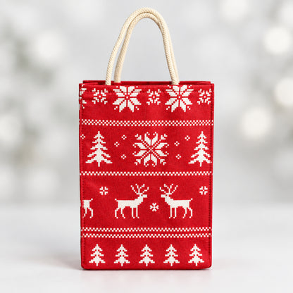 Fabric Gift Bag Small in a red holiday Nordic print with pine trees, snowflakes, and reindeers.