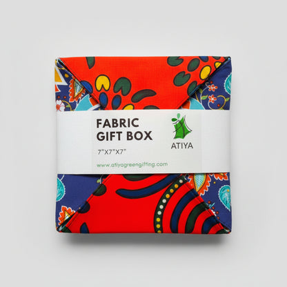 Eco-friendly gift box in a bold African print, in orange & blue with a ribbon closure.