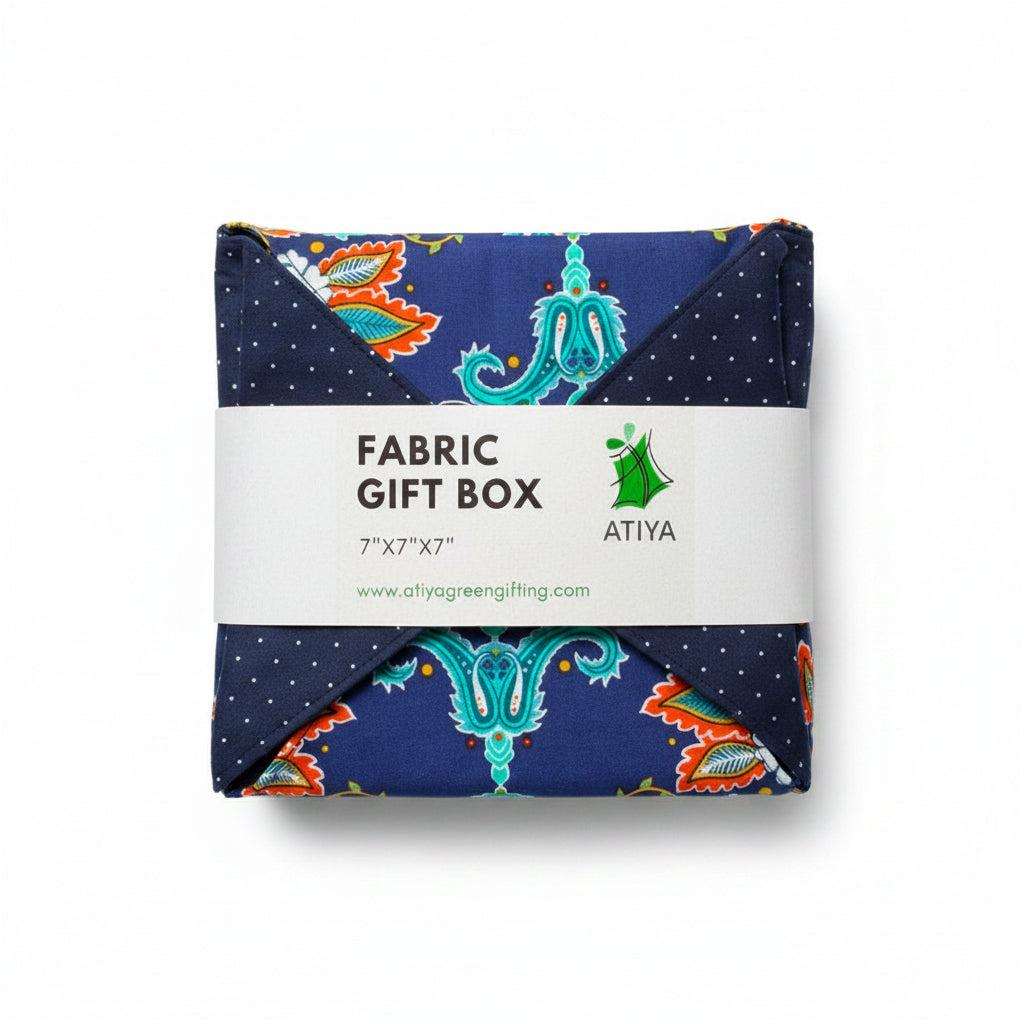 Reusable gift wrap in a bold African print, in orange & blue dots with a ribbon closure.