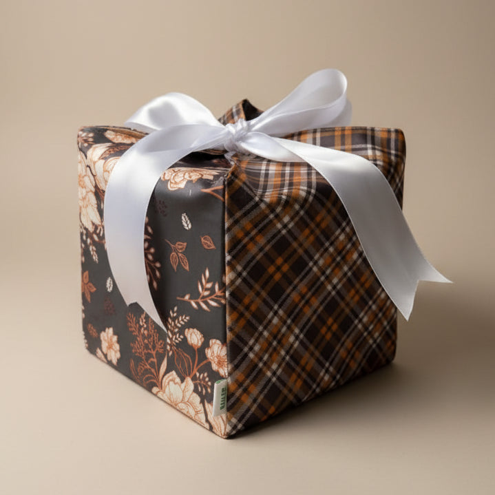 Reusable gift box with ribbon in a beautiful satin fabric with brown & orange checks & floral print.