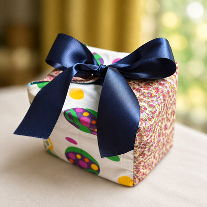 Fabric Gift Box in a multi-color dots and delicate magenta print with a blue ribbon closure in 7X7X7 inch size.