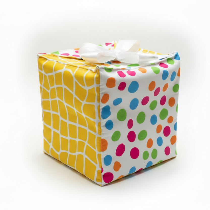 Fabric gift wrap in cotton fabric with multi-color dots & yellow checks, with a ribbon closure.