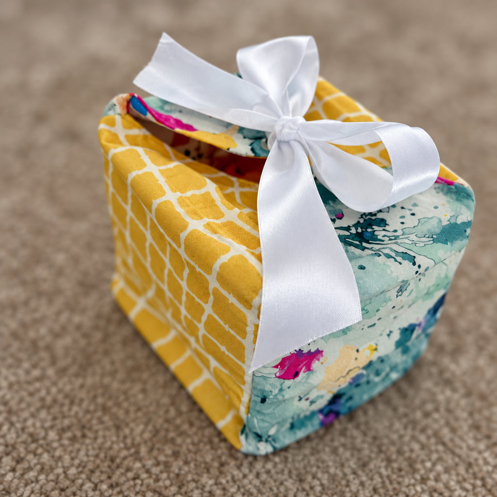 Fabric Gift Box in a yellow checks and abstract print with a white ribbon closure in 7X7X7 inch size.