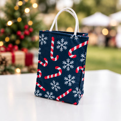 Fabric Gift Bag Small in a blue holiday print with candy canes and snowflakes.