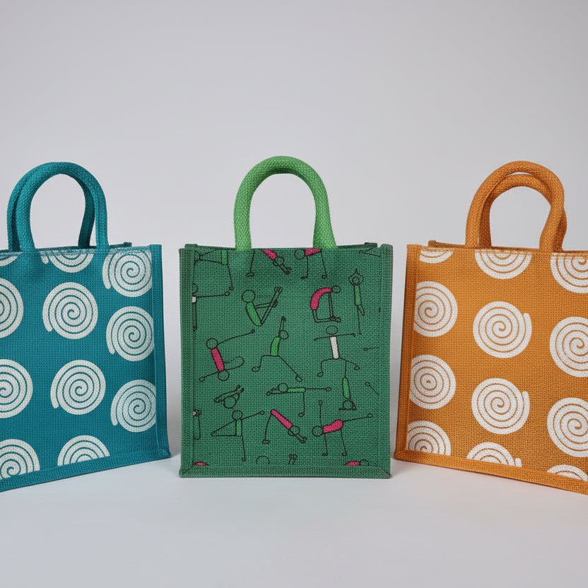 Three jute bags with spiral and abstract patterns on a bright background color.