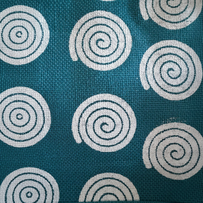 Teal fabric with white spiral patterns