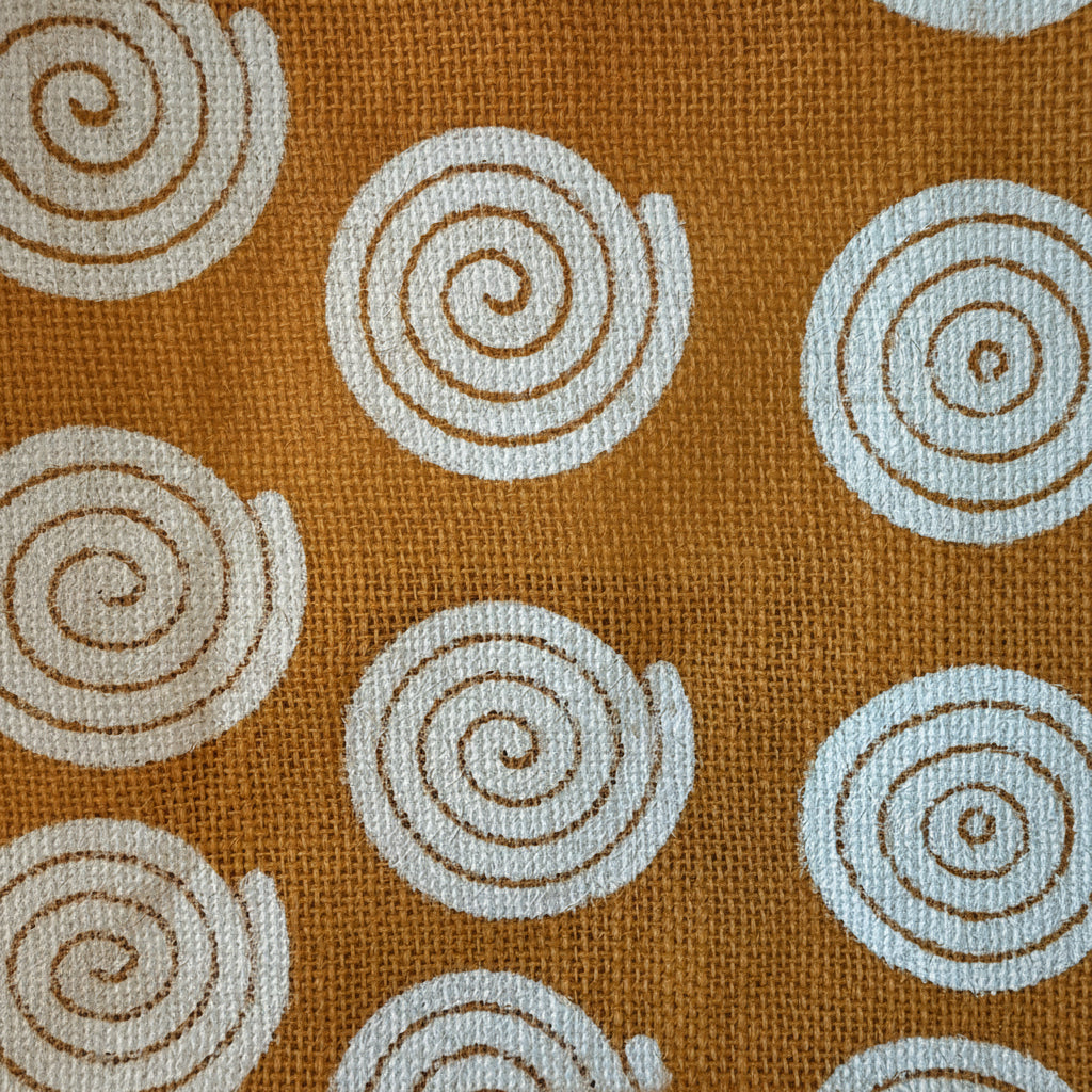 Orange fabric with white spiral patterns