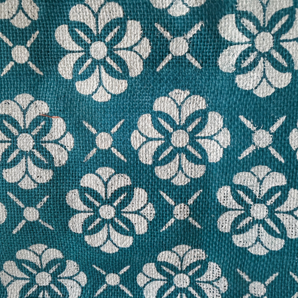 Teal fabric with white floral pattern