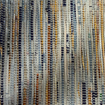 Close-up of upcycled handwoven Messenger Bag in navy blue and gold weave with a navy blue strap.