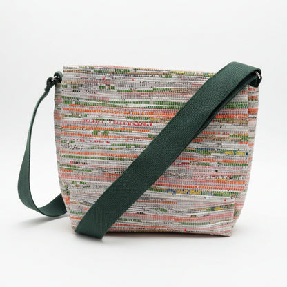 Upcycled handwoven Messenger Bag in orange and green weave with a dark green strap.