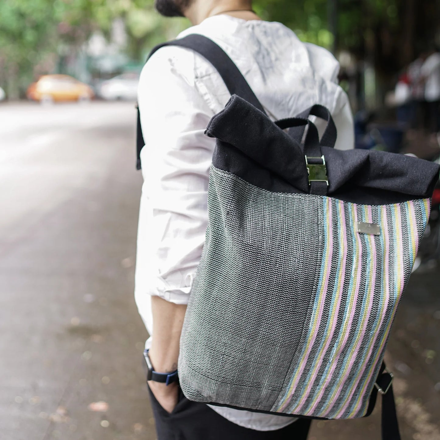 Lifestyle image of model carrying an Upcycled Spartan Backpack