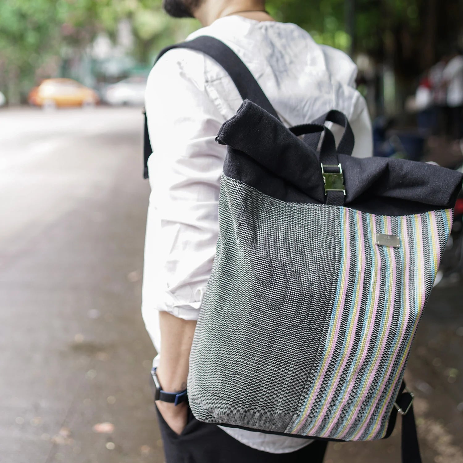 Lifestyle image of model carrying an Upcycled Spartan Backpack