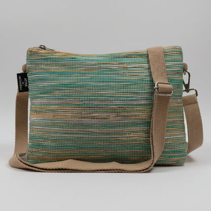 Upcycled handwoven Sling-It Bag in teal and gold weave with a beige strap.