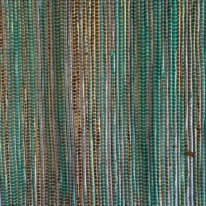 Close-up of upcycled handwoven Sling-It Bag in teal and gold weave with a navy beige strap.