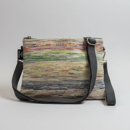 Upcycled handwoven Sling-It Bag in multicolored weave with a grey strap.