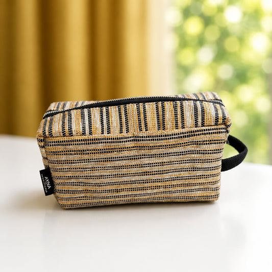 Upcycled handwoven travel pouch in gold with thin black & white stripes and a side loop for easy grab and go.