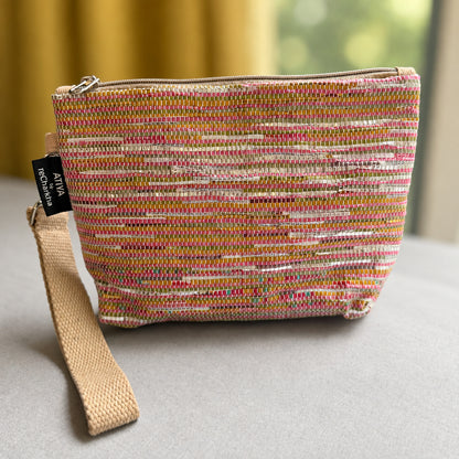 Upcycled handwoven Wrist-it bag in shades of pink & orange with a beige trim.