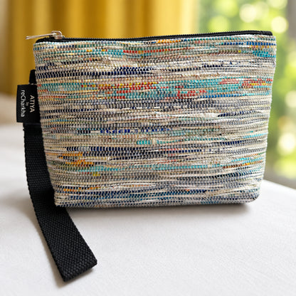 Upcycled handwoven Wrist-it bag in shades of blue & grey with a black trim.