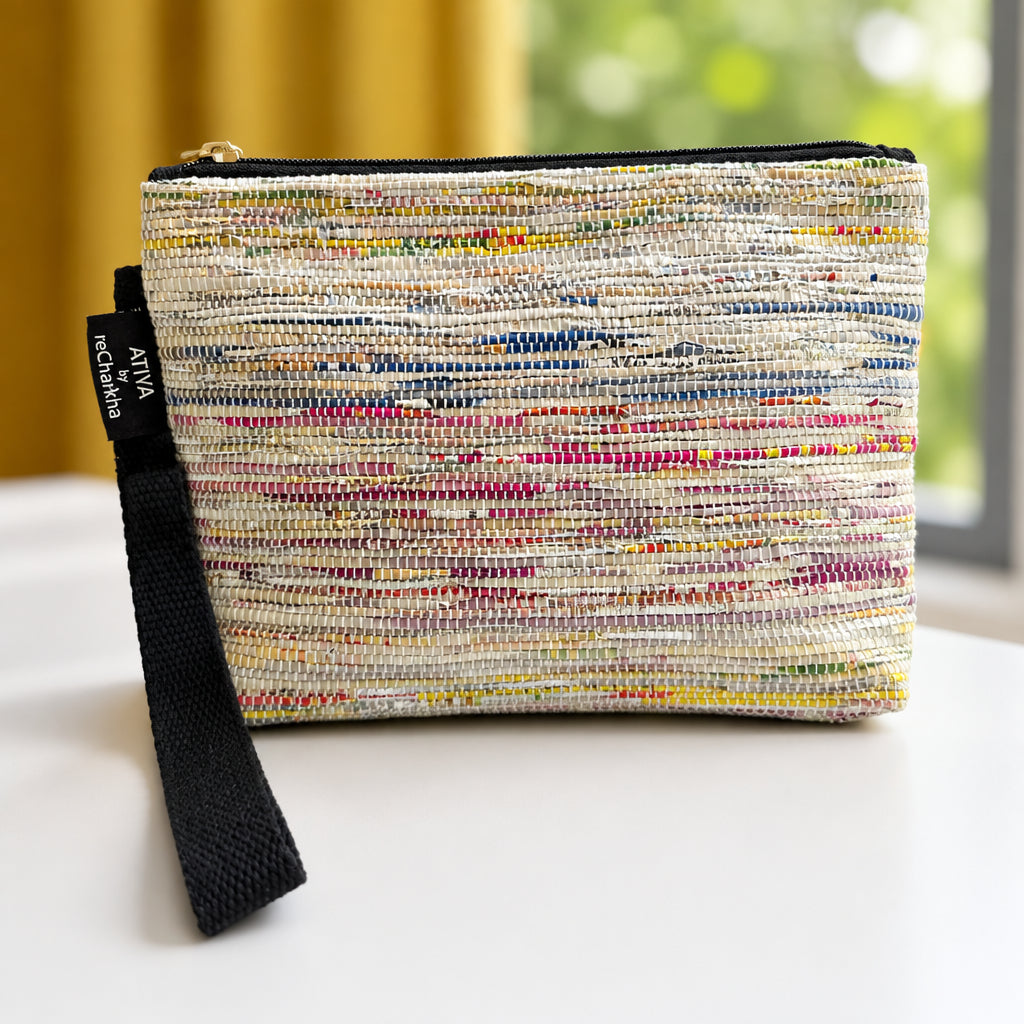 Upcycled handwoven Wrist-it bag in multi-color shades with a black trim.